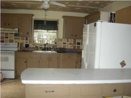 4858 Hinote Road DeFuniak Springs, FL 32433 - Photo 13 of 27 a kitchen with a refrigerator and a sink