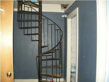 4858 Hinote Road DeFuniak Springs, FL 32433 - Photo 15 of 27 a view of staircase with lots of frames on wall and a window