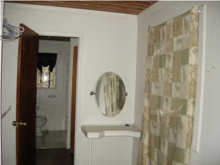 4858 Hinote Road DeFuniak Springs, FL 32433 - Photo 18 of 27 a bathroom with a mirror and a shower