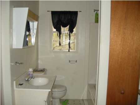 4858 Hinote Road DeFuniak Springs, FL 32433 - Photo 19 of 27 a bathroom with a sink and mirror with toilet