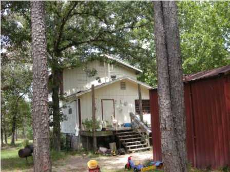 4858 Hinote Road DeFuniak Springs, FL 32433 - Photo 27 of 27 a front view of a house with yard and trees