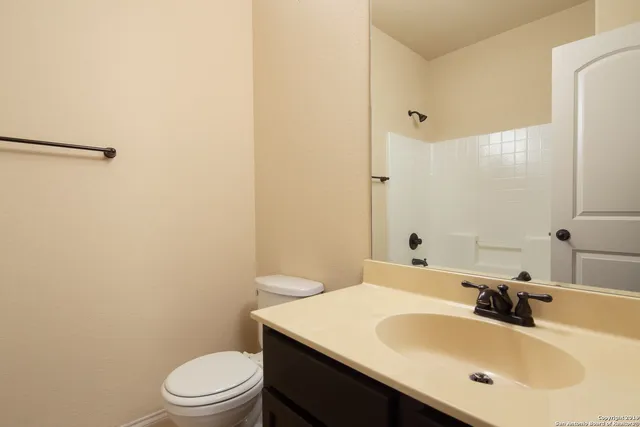 a bathroom with a sink toilet and mirror