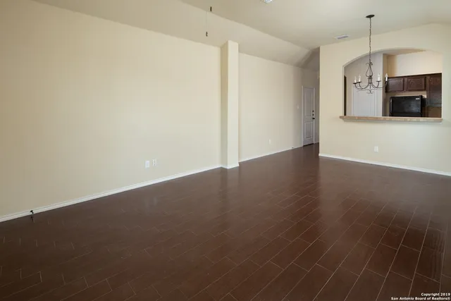 a view of a kitchen with wooden floor and a sink