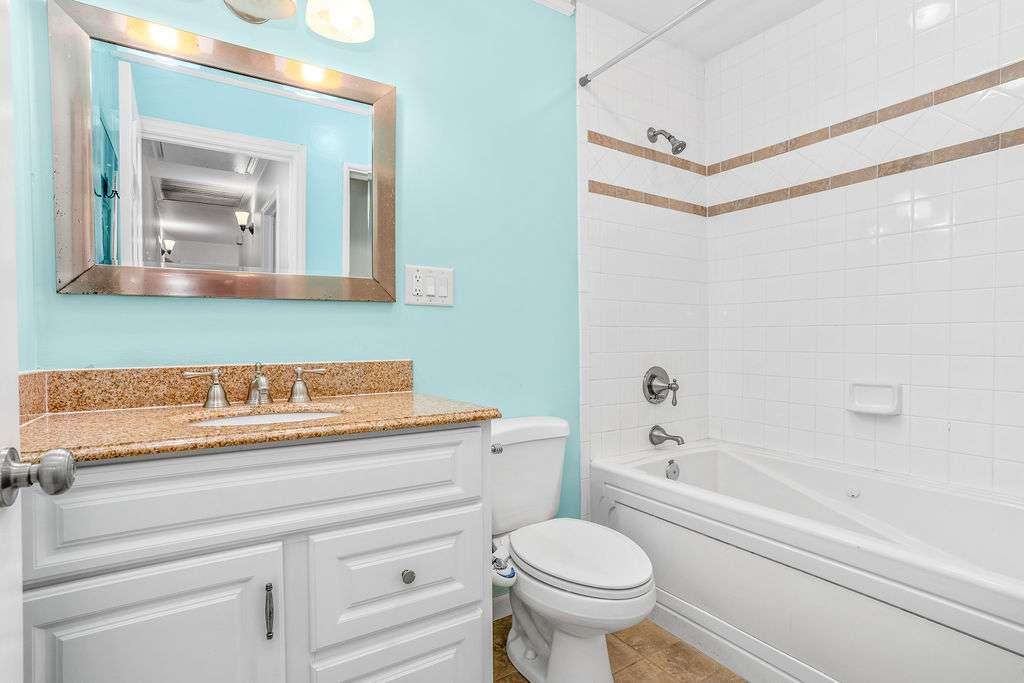 3911 Ivy Road Northeast Atlanta, GA 30342 - Photo 11 of 28 a bathroom with a sink a toilet and a bathtub