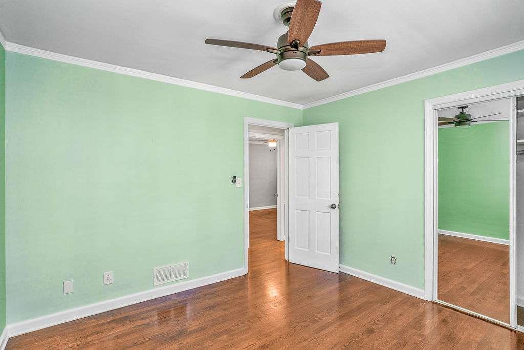3911 Ivy Road Northeast Atlanta, GA 30342 - Photo 14 of 28 a view of a room with wooden floor and ceiling fan