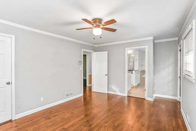 a view of an empty room with wooden floor