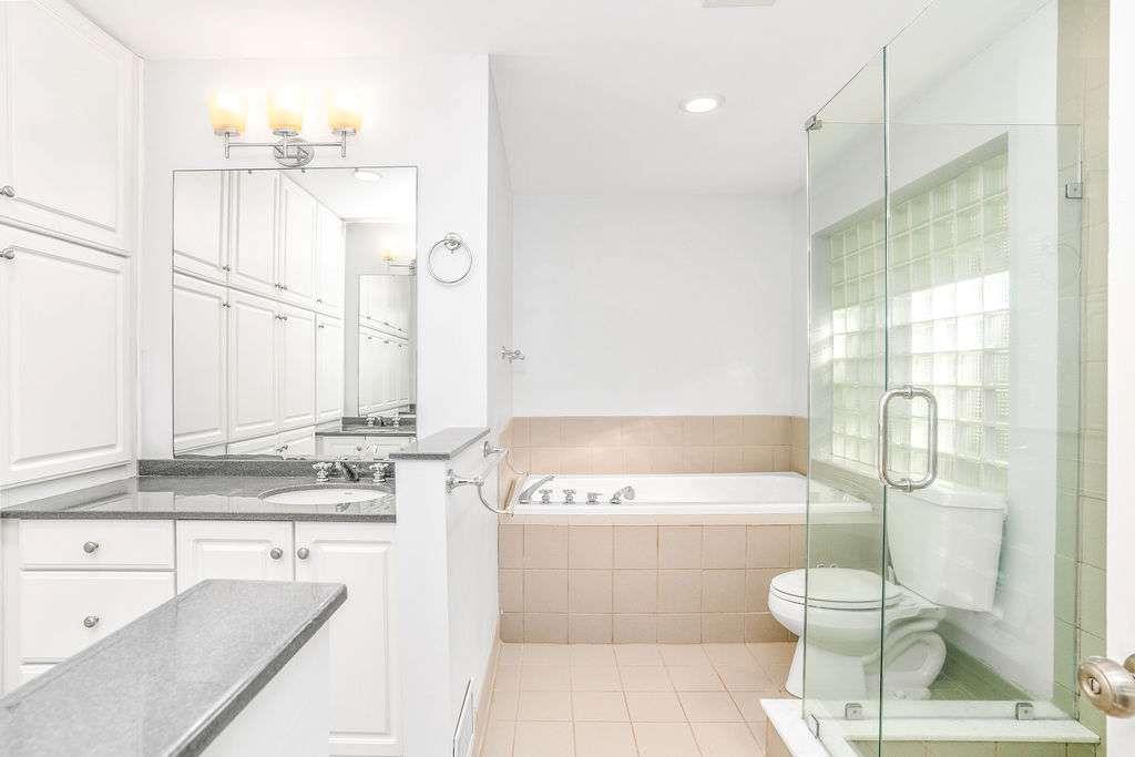 3911 Ivy Road Northeast Atlanta, GA 30342 - Photo 18 of 28 a bathroom with a sink a toilet and shower