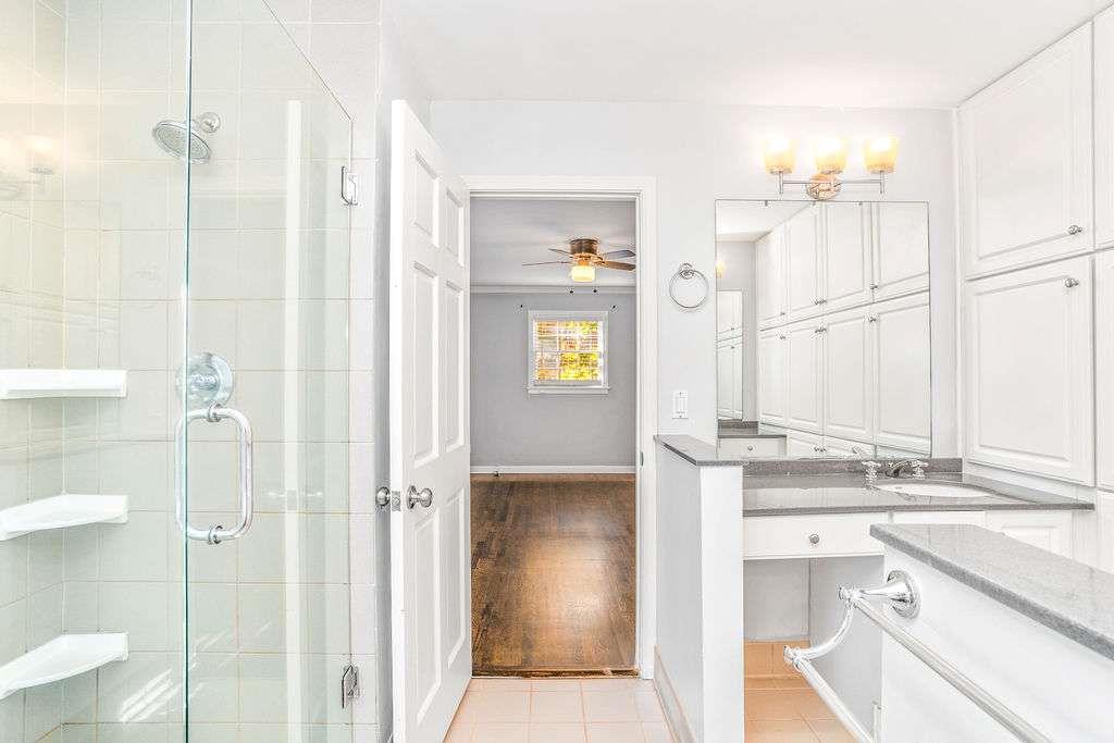 3911 Ivy Road Northeast Atlanta, GA 30342 - Photo 20 of 28 a bathroom with a sink and a mirror