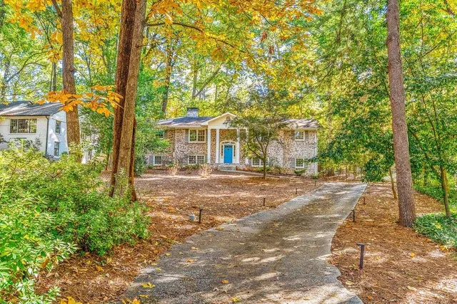front view of a house with a tree