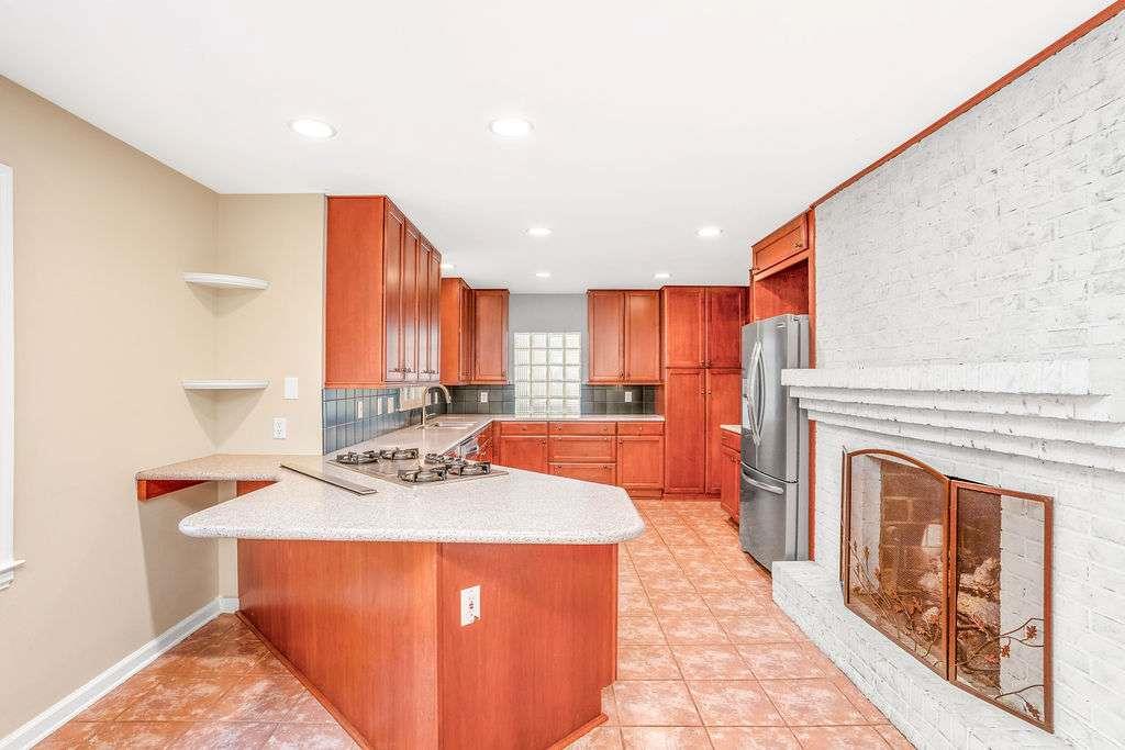 3911 Ivy Road Northeast Atlanta, GA 30342 - Photo 3 of 28 a kitchen with stainless steel appliances granite countertop a stove a sink and a refrigerator