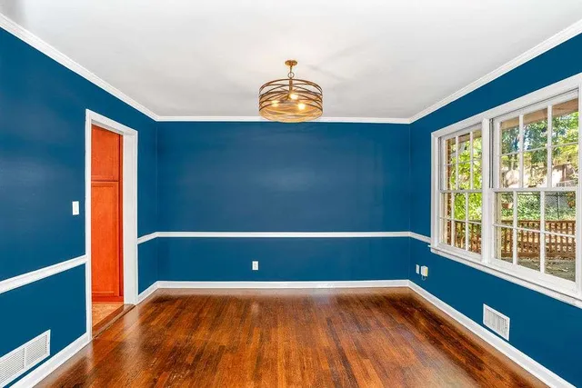 a view of room with window and wooden floor