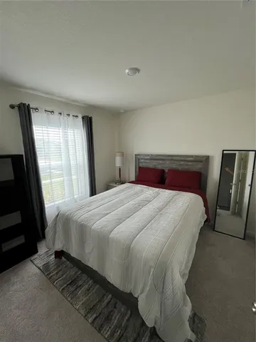 a bedroom with a bed and window