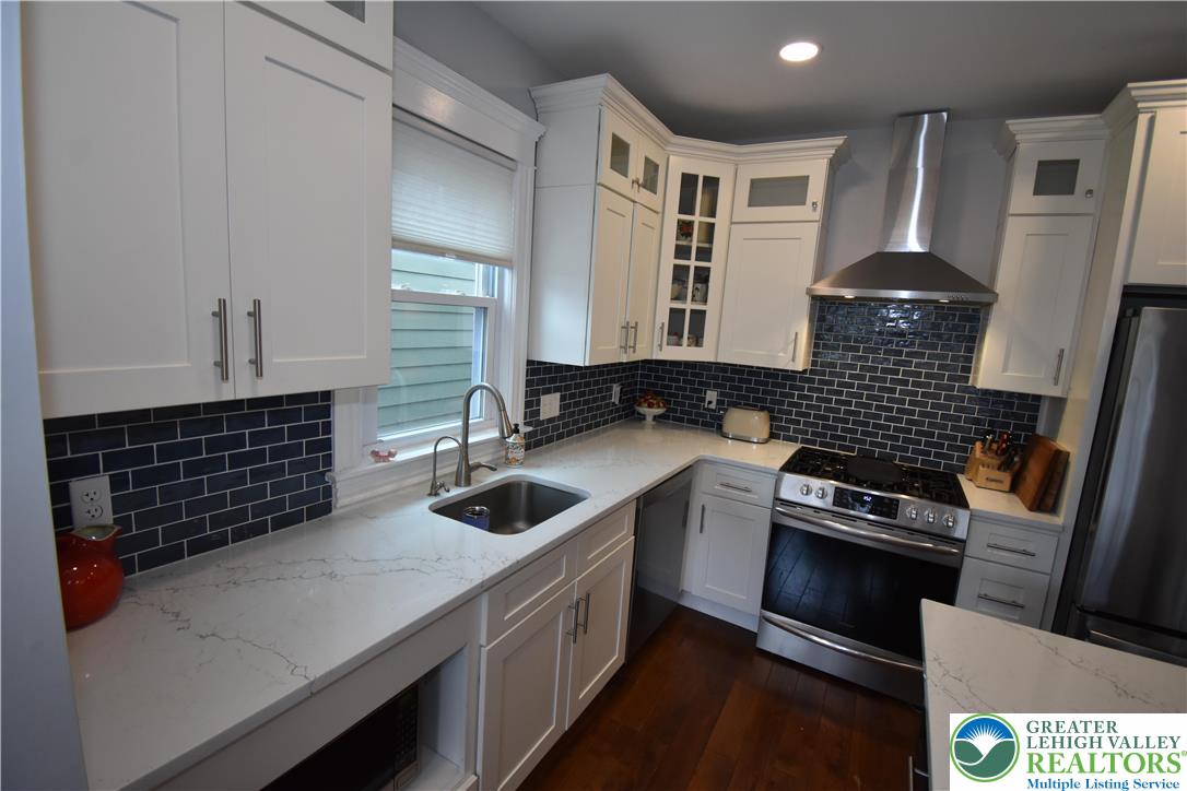 715 Coleman Street Easton, PA 18042 - Photo 13 of 38 a kitchen with a sink stove and cabinets
