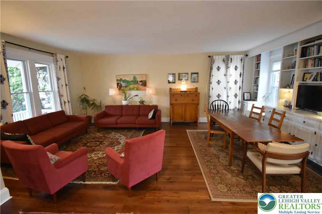 715 Coleman Street Easton, PA 18042 - Photo 7 of 38 a living room with furniture a flat screen tv and a large window
