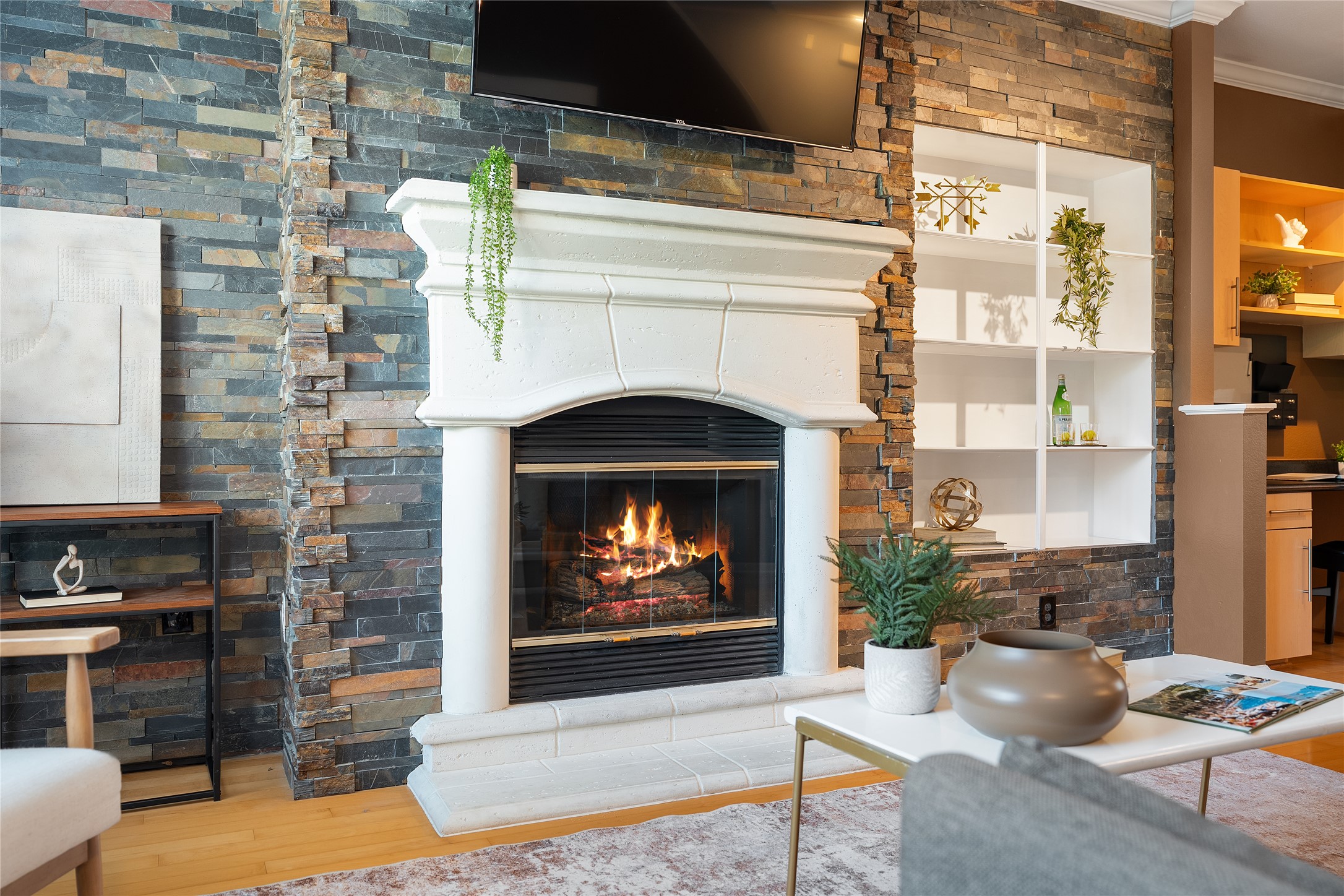 11203 Ranch Road 2222, Unit 1402 Austin, TX 78732 - Photo 3 of 22 A striking fireplace with a decorative mantel and hearth anchors this inviting living space.