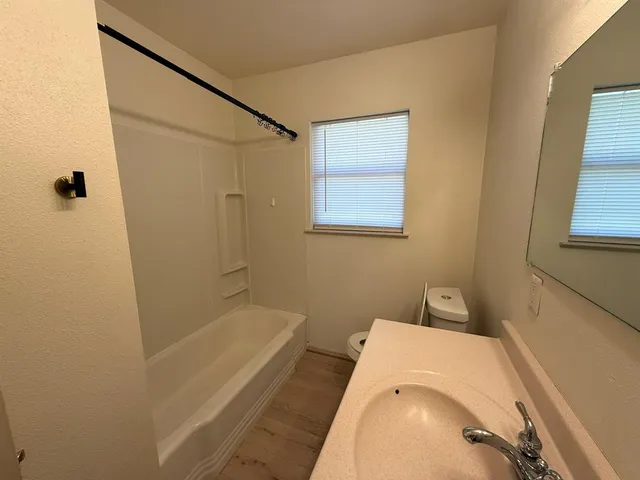 a bathroom with a tub and a shower