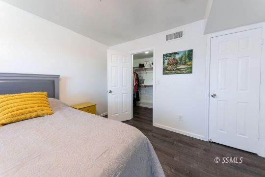 224 Richard Court Ridgecrest, CA 93555 - Photo 21 of 49 a bedroom with a bed and cupboard