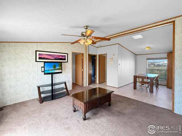 a living room with furniture a dining table and a chandelier