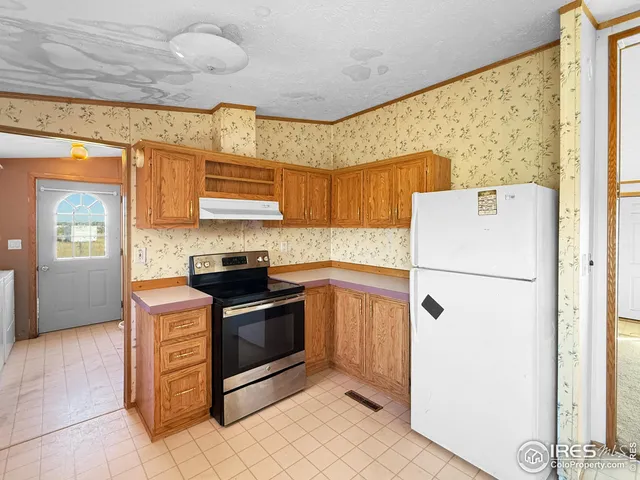 a kitchen with a stove a refrigerator and a sink