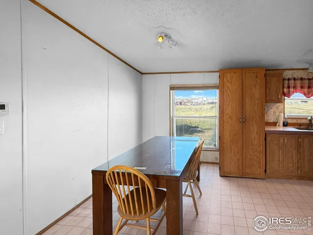 a view of a dining room with furniture and window