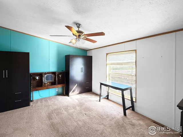a living room with furniture and a ceiling fan