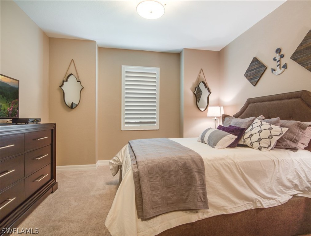 9495 Piacere Way Naples, FL 34113 - Photo 15 of 25 a bedroom with a bed and cabinets