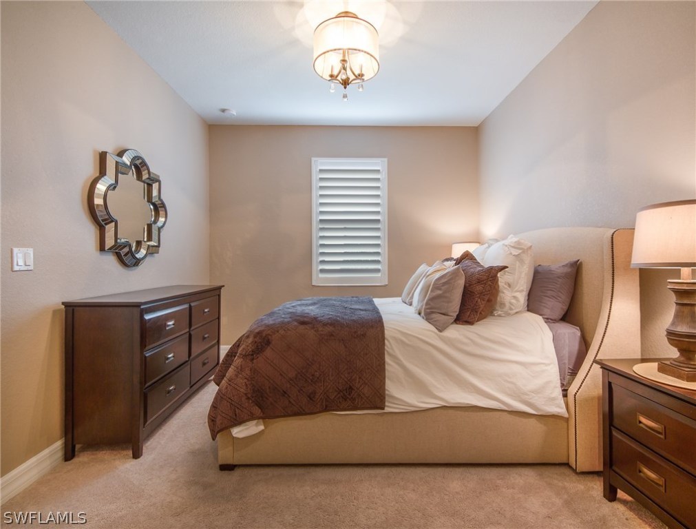 9495 Piacere Way Naples, FL 34113 - Photo 17 of 25 a bedroom with a bed and a table