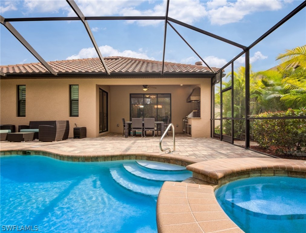 9495 Piacere Way Naples, FL 34113 - Photo 22 of 25 a view of a house with swimming pool and furniture