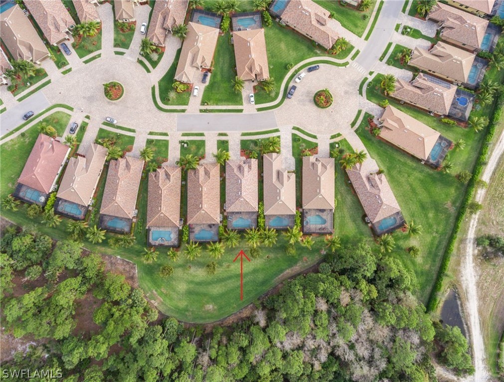 9495 Piacere Way Naples, FL 34113 - Photo 24 of 25 an aerial view of residential house with outdoor space and parking