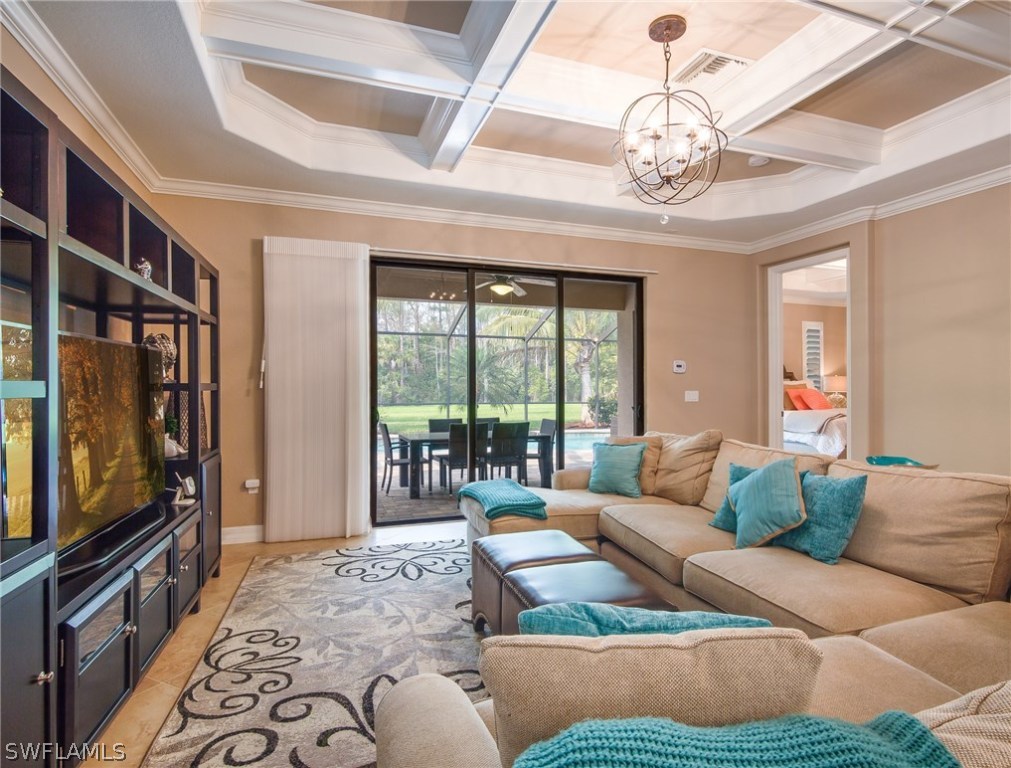 9495 Piacere Way Naples, FL 34113 - Photo 5 of 25 a living room with furniture and a flat screen tv
