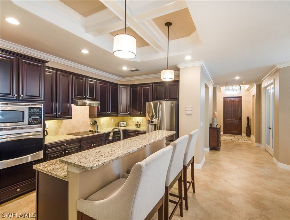 9495 Piacere Way Naples, FL 34113 - Photo 8 of 25 a large kitchen with a table and chairs
