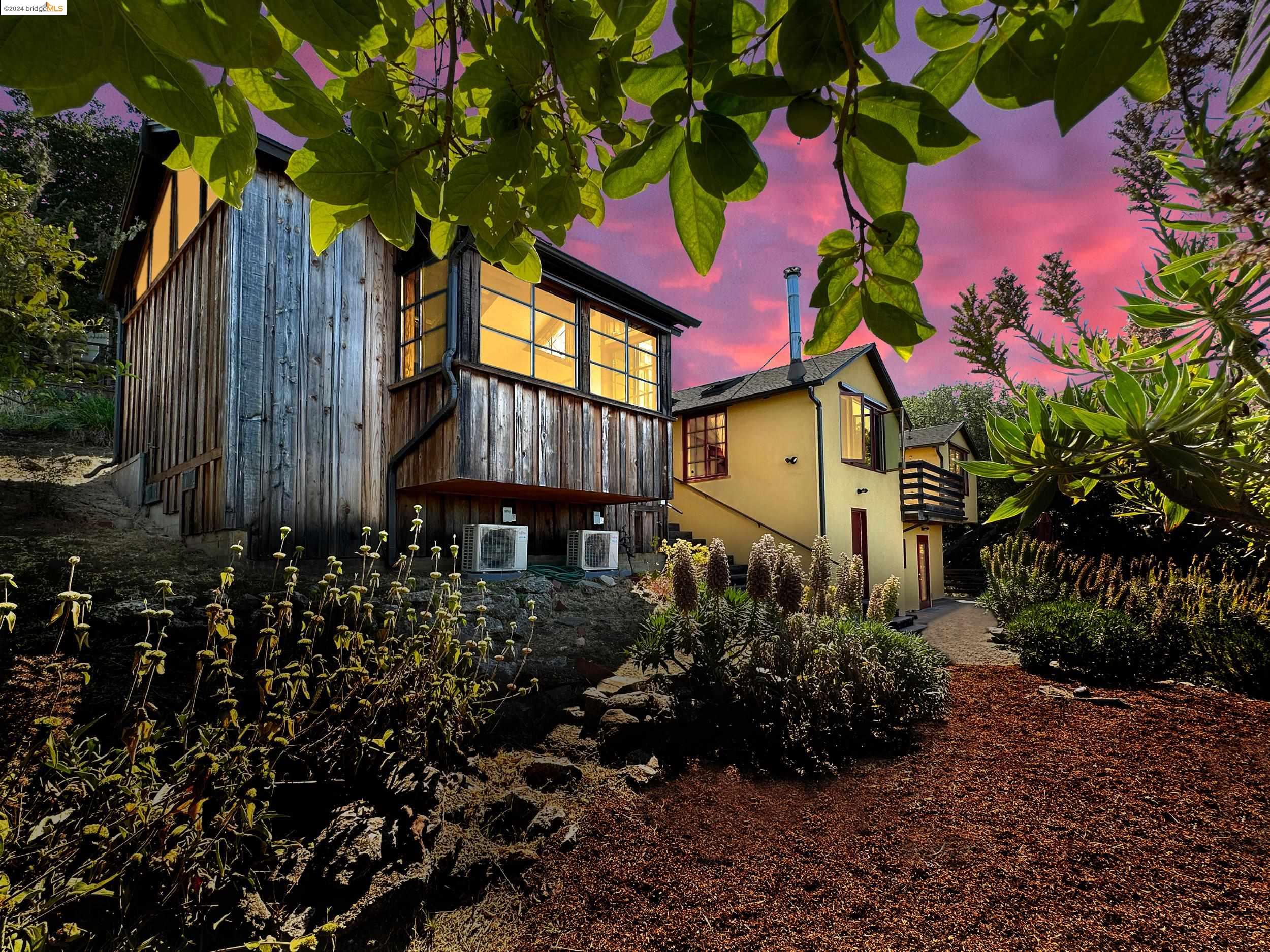 a view of a house with a yard and garden