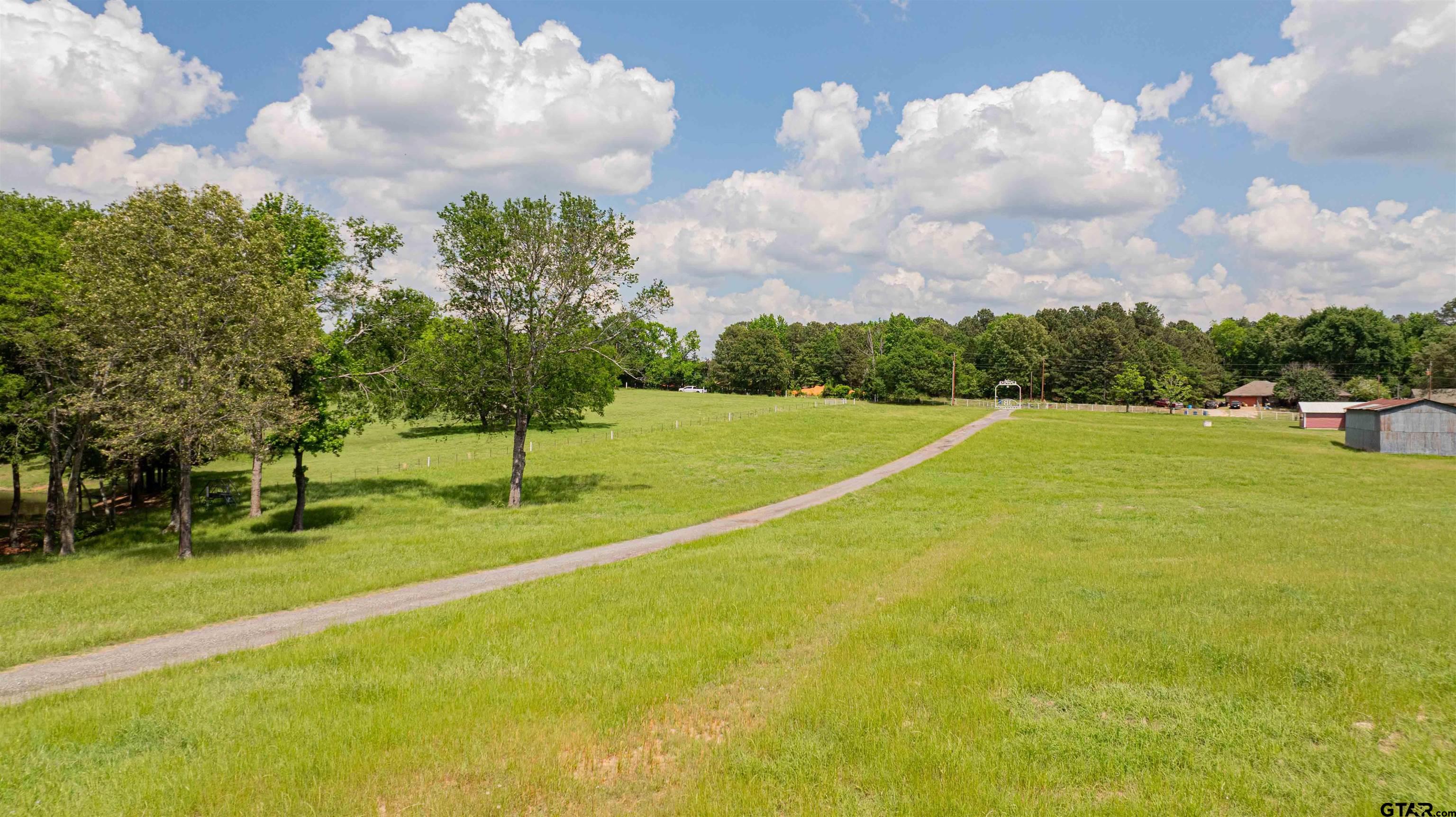 1855 Phillips Springs Road Gladewater, TX 75647 - Photo 23 of 36 a view of a playground with basketball court