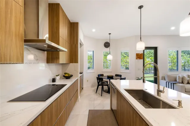 a kitchen with stainless steel appliances granite countertop sink stove and cabinets