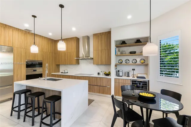 a kitchen with a table chairs stove and cabinets