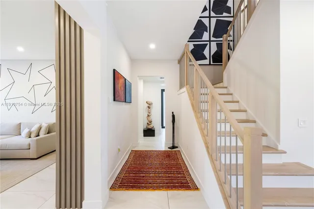 a view of entryway and hall with wooden floor