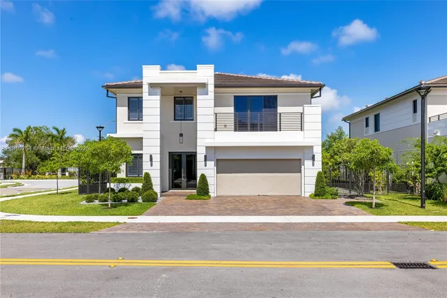 a front view of a house with a yard and garage