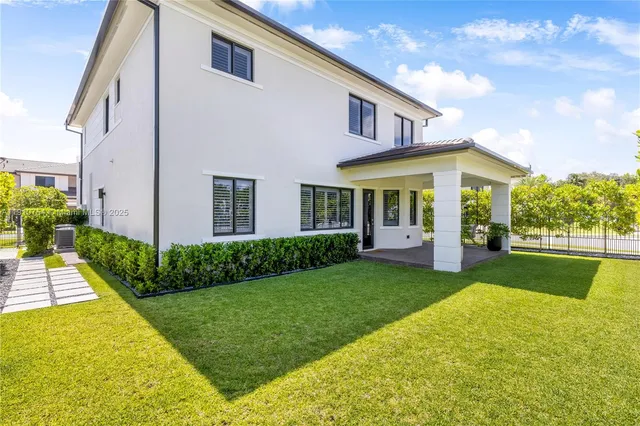 a view of house that has a yard