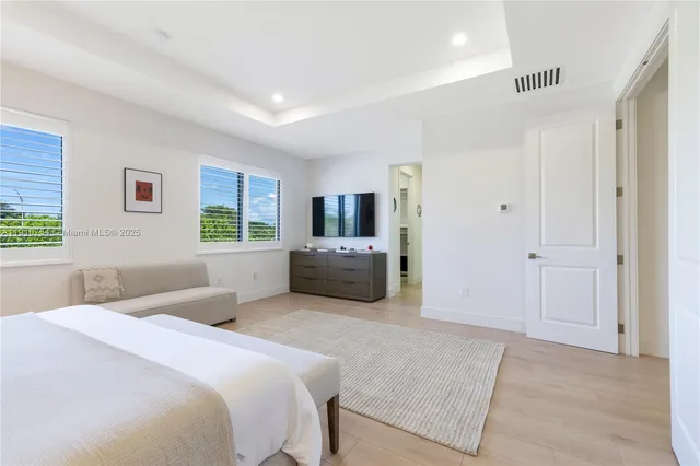 a bedroom with a bed and a television