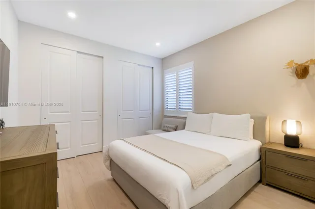 a bedroom with a bed and a night stand