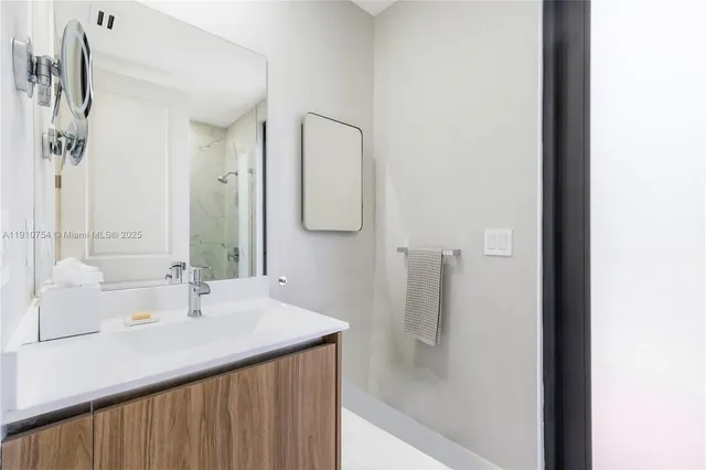 a bathroom with a sink mirror and a bathtub