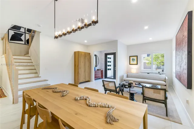 a view of a dining room with furniture and a chandelier