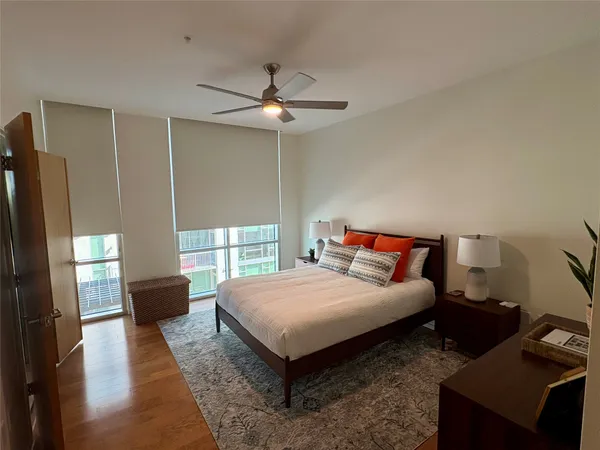 a bedroom with a bed and wooden floor