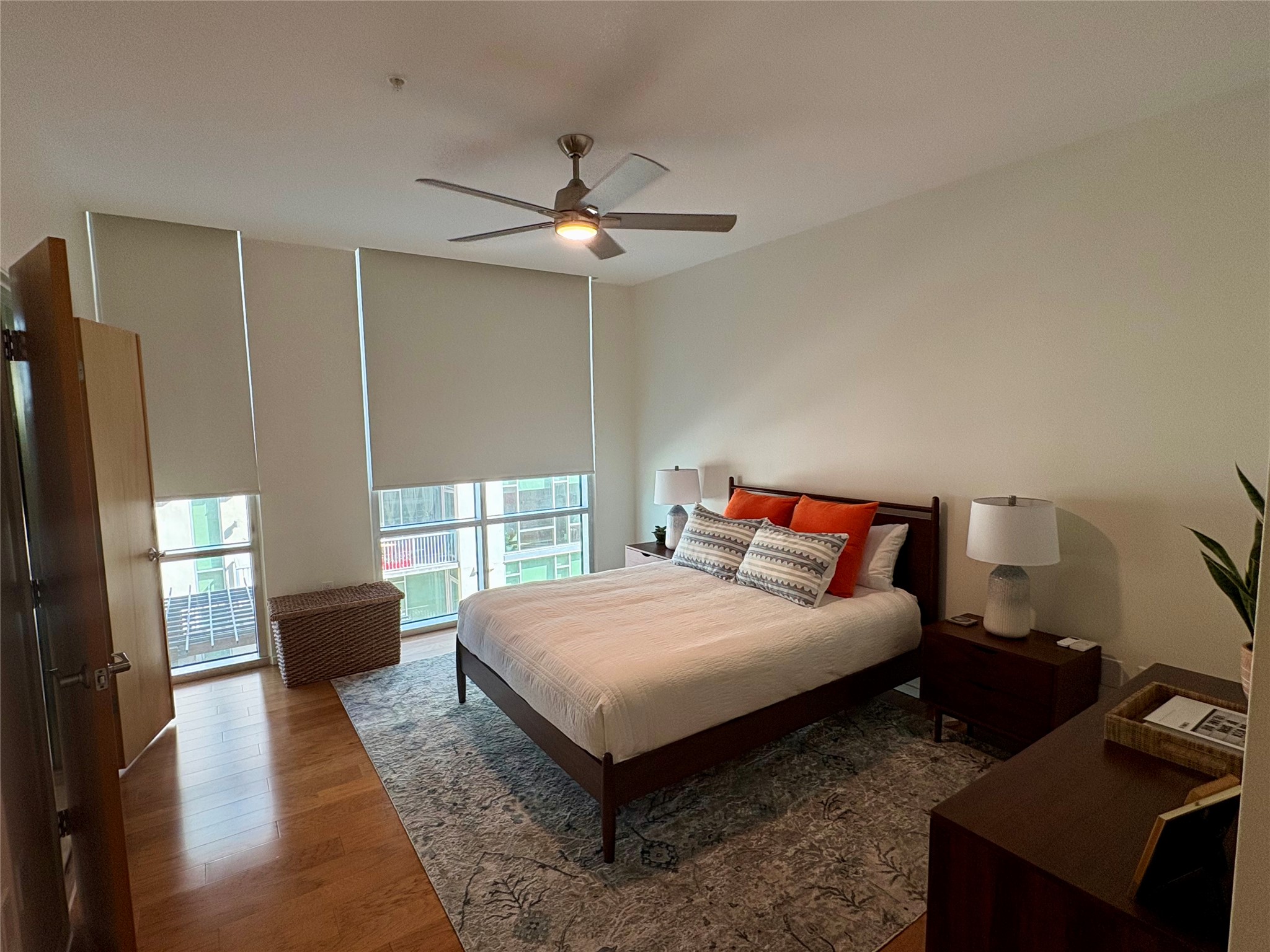 1600 Barton Springs Road, Unit 1301 Austin, TX 78704 - Photo 13 of 27 a bedroom with a bed and wooden floor