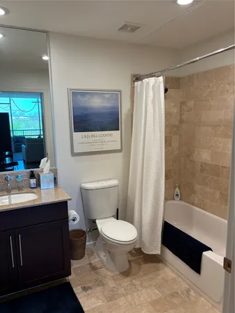 a bathroom with a toilet a sink and bathtub