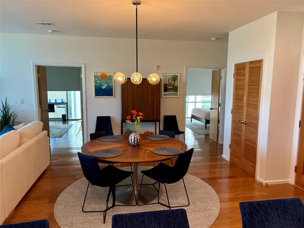 a view of a dining room with furniture and wooden floor