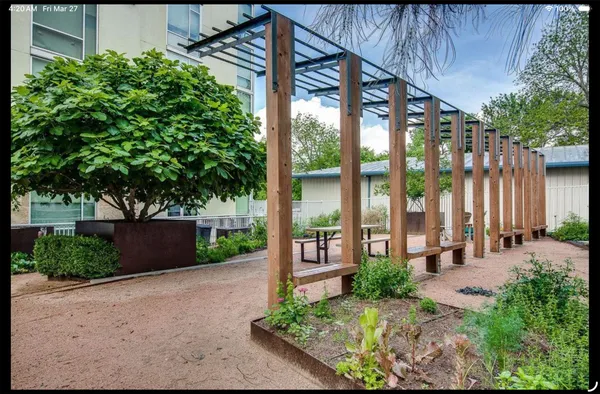 a view of a garden with an outdoor seating
