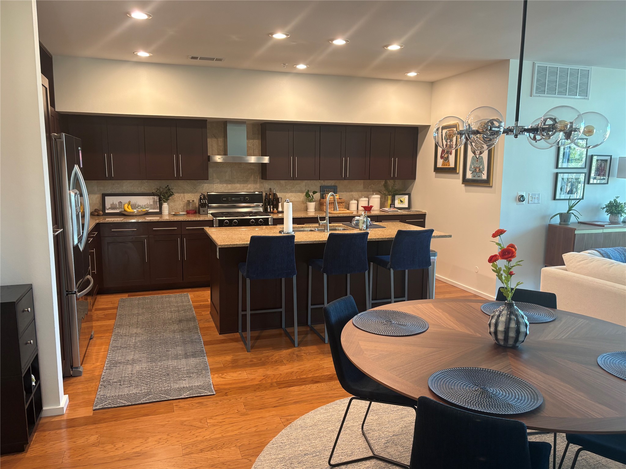 1600 Barton Springs Road, Unit 1301 Austin, TX 78704 - Photo 27 of 27 a kitchen with stainless steel appliances granite countertop a stove a sink dishwasher and a dining table