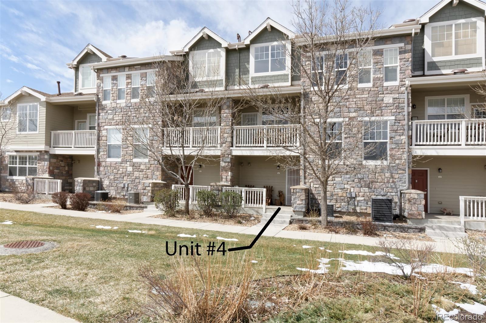 8440 Canyon Rim Trail, Unit 4 Parker, CO 80134 - Photo 1 of 28 a view of a building with a swimming pool