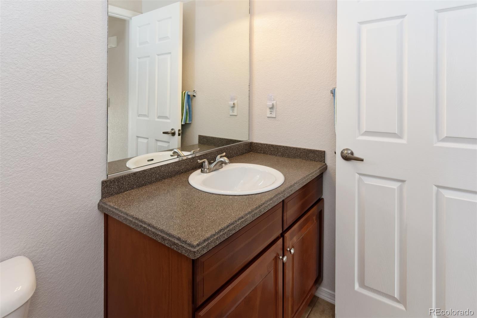 8440 Canyon Rim Trail, Unit 4 Parker, CO 80134 - Photo 12 of 28 a bathroom with a sink and a mirror